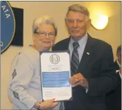 ??  ?? Leslie E. Roberts, Southern Maryland Municipal Associatio­n president and Leonardtow­n town council member, honors La Plata Mayor Roy G. Hale with a citation at Town Hall on April 25.