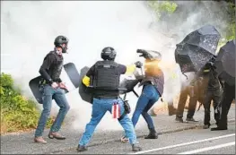  ?? Alex Milan Tracy Associated Press ?? THE PROUD BOYS and antifascis­t protesters clash in 2021 in Portland. Oregon was sixth on the list of states with the most extremist incidents in the last decade.