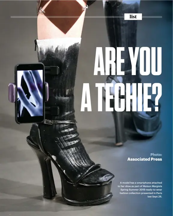  ?? Photo: Associated Press ?? A model has a smartphone attached to her shoe as part of Maison Margiela Spring Summer 2019 ready-to-wear fashion collection presented in Paris last Sept.26.