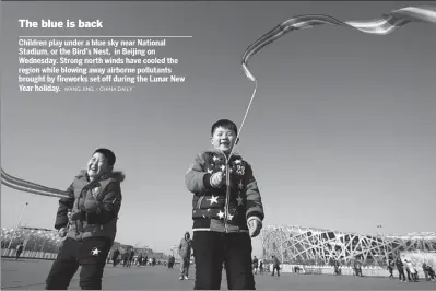  ?? WANG JING / CHINA DAILY ?? Children play under a blue sky near National Stadium, or the Bird’s Nest, in Beijing on Wednesday. Strong north winds have cooled the region while blowing away airborne pollutants brought by fireworks set off during the Lunar New Year holiday.