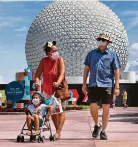  ?? Joe Burbank / Associated Press ?? Guests attend the official reopening Wednesday of Epcot at Walt Disney World in Lake Buena Vista, Fla. All four of Disney’s Florida parks are now open.