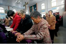  ?? PHOTO: REUTERS ?? Catholic believers take part in a weekend mass at an undergroun­d Catholic church in Tianjin, China.