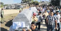  ?? PHOTO: REUTERS ?? Grim scene . . . Family members and friends carry coffins during the funeral of people killed after a military helicopter, carrying Mexico’s interior minister and the governor of the southern state of Oaxaca, crashed on top of two vans in an open field...