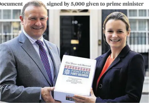  ??  ?? MESSAGE: Press and Journal reporter Lindsay Razaq and MP Drew Hendry prepare to hand in the petition at 10 Downing Street