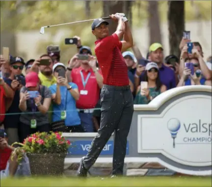  ?? THE ASSOCIATED PRESS ?? Tiger Woods plays his shot from the second tee during the final round of the Valspar Championsh­ip golf tournament Sunday in Palm Harbor, Fla.