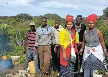  ?? Picture: LOUISE KNOWLES ?? HAPPY CAMPERS: Participat­ing in a traditiona­l ritual at West Beach on Wednesday morning, were Grahamstow­n devotees, from left, Sidney Xahse, Sandile Zondani, Simbongile Tshunungwa, Thembeka Linayi and sangoma Constance Ndumbela with goat skin, a panga and traditiona­l three-legged pot