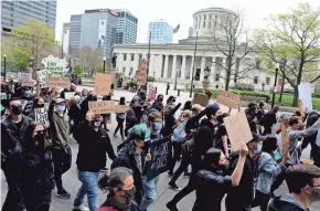  ??  ?? Protesters march down South High Street near the Ohio Statehouse. The protest was held in response to police killing of Black people. About 150 protesters marched as they called for justice in recent police killings.