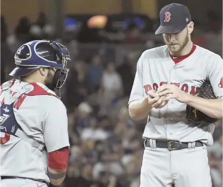  ?? AP PHOTO ?? NOT A GOOD NIGHT: Starter Chris Sale gets a visit from catcher Sandy Leon during the Sox’ series finale against the Yankees last night in New York.