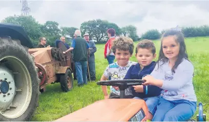  ??  ?? Roy’s three grandchild­ren, Soffia, Dafydd and Trystan getting into the spirit of the event on the little Kubota.