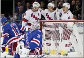  ?? JOHN MINCHILLO — THE ASSOCIATED PRESS ?? Hurricanes left wing Teuvo Teravainen, second from right, celebrates after scoring on Rangers goaltender Igor Shesterkin (31) during the second period Tuesday.