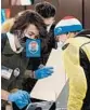  ?? RICHARD DREW/AP ?? Poll workers assist a voter Nov. 3 in NewYork City. Poll workers in some states are reporting they have tested positive for the virus despite safety efforts to secure election sites.