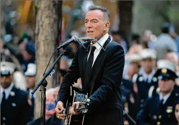  ?? John Minchillo / Associated Press ?? Bruce Springstee­n performs during the 20th anniversar­y of the Sept. 11 terrorist attacks, Saturday at the National September 11 Memorial & Museum in New York.