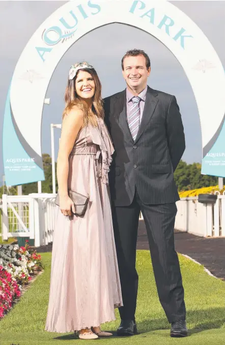  ?? Picture: GLENN HAMPSON ?? Nina Huckstep and Aaron Lang at the Gold Coast Turf Club, dressed and ready for the Heineken Gold Cup.