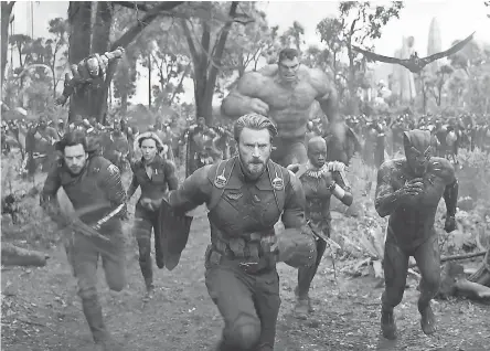  ??  ?? Captain America (Chris Evans, center) and Black Panther (Chadwick Boseman, right) lead their allies in the fight against invading villains in “Avengers: Infinity War” this May. Recognize anyone else in there? MARVEL STUDIOS