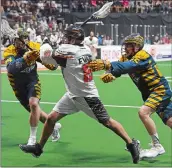  ??  ?? New England’s Shawn Evans (15) takes a shot between Georgia defenders Jordan MacIntosh, left, and Jason Noble (45) during a National Lacrosse League playoff game in 2016. The Black Wolves traded the popular Evans to the Buffalo Bandits on Wednesday for...