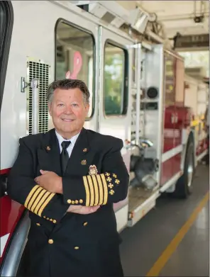  ?? KELVIN GREEN/THREE RIVERS EDITION ?? Bill Baldridge stands in front of the firetrucks at the Searcy Fire Department. Along with being a fire chief, Baldridge has also been the pastor at Greater Vision Sancturay in Beebe for nearly 30 years.