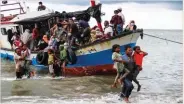  ??  ?? ANTARA FOTO/REUTERS Locals evacuate Rohingya refugees from a boat at a coast of North Aceh, Indonesia, on June 25, 2020.