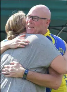  ?? PETE BANNAN – MEDIANEWS GROUP ?? National EMS Memorial Bike Ride participan­t Brad Blackman hugs Jennifer Kauffman, daughter of Crozer Emergency Medical Services Chief Robert ‘Bob’ Reeder, who died in October. Blackman is riding in honor of Reeder.