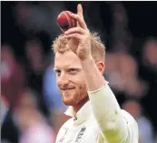  ??  ?? England's Ben Stokes holds up the ball as the team leave the pitch after taking his sixth wicket on the first day of the third Test at Lord's ground. West Indies were bowled out in just 123 runs. However Windies bowlers had reduced England to 15-2 when...