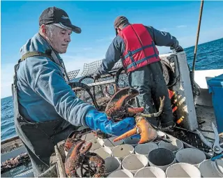  ??  ?? Sidney Clark, the son and grandson of fishermen, leaves before dawn each morning on his boat, the Sandcov'r, to check his 273 lobster traps.