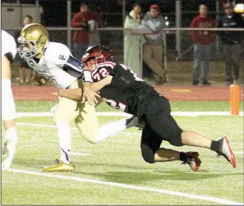  ?? Photograph­s courtesy of Russ Wilson ?? Blackhawk senior Seth Trammell (No. 72) brought down Saint Connor Reece (No. 3) during Friday night’s semi-final contest in Blackhawk Stadium.