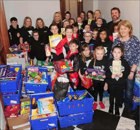  ??  ?? Rose Bailey, St. Patrick Church’s Soup Kitchen, with members of the D-mas-F Kickboxing and Crystal Ice Dance groups who donated food parcels to St. Patrick Church’s Soup Kitchen.