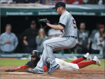  ?? RON SCHWANE — THE ASSOCIATED PRESS ?? The Indians’ Carlos Santana scores on a wild pitch by Tigers relief pitcher Drew VerHagen during the sixth inning.