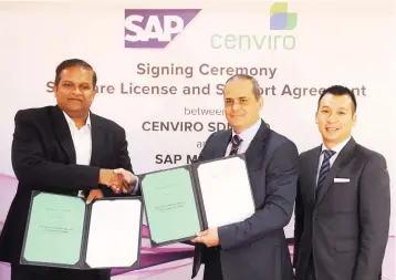  ??  ?? Khalid (middle) exchanging documents with executive director of the South East Asia Advisory Deloitte Sdn Bhd Pankaj Rathi (left) during the signing of software license and support agreement at Mercu UEM yesterday. Also present is Managing Director of...