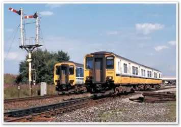  ??  ?? Sadly, this semaphore bracket at Kirkham North Junction was replaced by a three-aspect colour light with a position 4 junction indicator not long after this view was taken on 21 July 1997. 156424, forming the 1603 Blackpool North-Manchester Airport, is signalled onto the Up Fast line. Being the higher speed route, the signal arm is placed higher than that applying to the Up Slow. After stopping at Kirkham, 150207 is leaving the Down Slow. Whereas the Class 156 is adorned with normal Regional Railways livery, the Class 150/1 features Merseyrail colours.