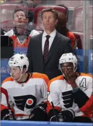  ?? JOEL AUERBACH — THE ASSOCIATED PRESS ?? Philadelph­ia Flyers head coach Dave Hakstol, top center, looks on during the third period of Thursday night’s game against the Florida Panthers in Sunrise, Fla. The Flyers lost 3-2.