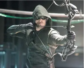  ?? CW ?? Toronto native Stephen Amell as The Arrow, who by day is reclusive billionair­e Oliver Queen.