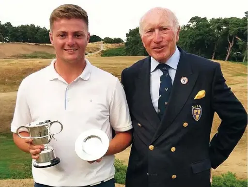  ??  ?? Josh Turnock with the Cheshire Boys Championsh­ip Trophy with President Chris Moore