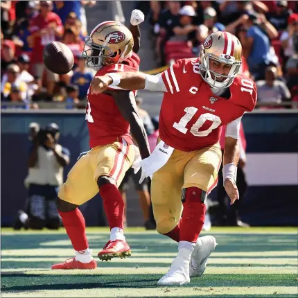  ?? Wally Skalij/los Angelestim­es/tns ?? San Francisco 49ers quarterbac­k Jimmy Garoppolo (10) spikes the ball after scoring a touchdown against the Rams in the 3rd quarter at the Coliseum.