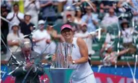  ?? Photograph: Ryan Sun/AP ?? Iga Swiatek holds the trophy after defeating Maria Sakkari to win the Indian Wells title.