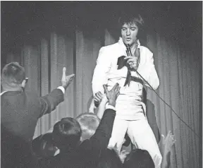  ?? COURTESY OF ELVIS PRESLEY ENTERPRISE­S ?? Elvis Presley performs on stage in 1969.