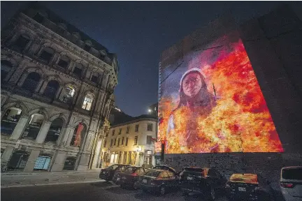  ?? PETER McCABE ?? Marie-Joseph Angélique is shown in a Cité Mémoire video projection in Montreal. Angélique was a slave who was sentenced to hang in 1734 after she was accused of setting a fire that spread across what is now Old Montreal.