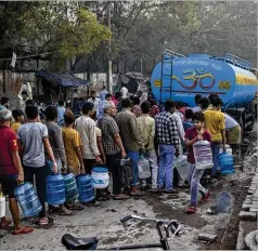  ?? ALTAF QADRI/AP ?? People await drinking water from a tanker in New Delhi on Wednesday, World Water Day. What the world does about water woes is the key question at a threeday U.N. water conference that began Wednesday in New York City.