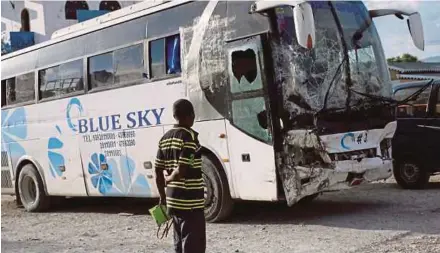  ?? REUTERS PIC ?? The bus, which drove into pedestrian­s, at the police station in Gonaives, Haiti.