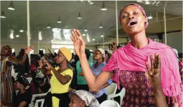  ??  ?? People praise the lord during the ‘singles summit’ held at Prayer City. — AFP photos