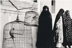  ??  ?? Veiled women and caged cockatoos in Iran, taken by Morath in 1956