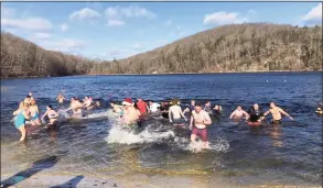  ?? Special Olympics Connecticu­t / Contribute­d photo ?? Residents braved nippy weather on Sunday to participat­e in Special Olympics Connecticu­t’s Penguin Plunge at Martin Park Beach.