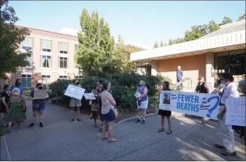  ?? RILEY BLAKE — ENTERPRISE-RECORD ?? Chico residents hold a vigil Tuesday at the City Council Chambers in Chico following the death of Guy Steven Vanzant.