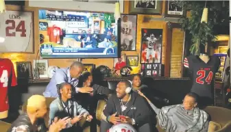  ?? NFL via Getty Images 2020 ?? Terrell Lewis ( center) is congratula­ted upon being taken by the Los Angeles Rams in the third round of the NFL draft on April 24. The NFL and the NBA held virtual drafts for the first time.