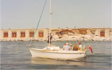  ??  ?? A sailboat passes by Hurst Castle on the English Channel, alongside the collapsed wall of the east wing.