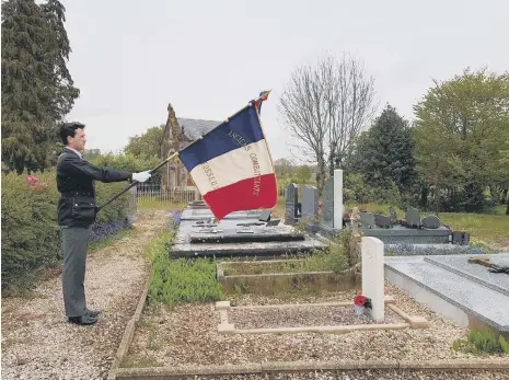  ??  ?? The flag bearer at the graveside of Private Thomson.