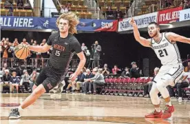  ?? ?? Jake Davis of Mercer dribbles the ball during a game for the Bears. Davis announced his commitment to the Illinois men's basketball team on Monday.