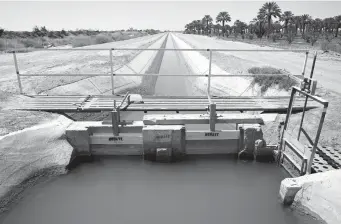  ?? Tribune News Service/getty Images ?? An irrigation ditch carrying river water toward Quechan tribal land along the long-depleted Colorado River is pictured on May 26 near Winterhave­n.