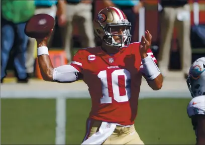  ?? NHAT V. MEYER — BAY AREA NEWS GROUP ?? San Francisco 49ers starting quarterbac­k Jimmy Garoppolo (10) throws against the Miami Dolphins in the first quarter at Levi’s Stadium in Santa Clara on Oct. 10.