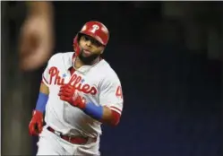  ?? BRYNN ANDERSON — THE ASSOCIATED PRESS ?? The Philadelph­ia Phillies’ Carlos Santana rounds third after hitting a solo home run during the first inning of Tuesday night’s game against the Miami Marlins.