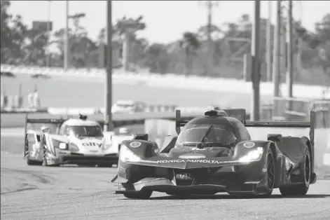  ?? ASSOCIATED PRESS ?? RICKY TAYLOR IN THE ACURA DPI leads Simon Pagenaud of France through the east horseshoe turn during the auto race at Daytona Internatio­nal Speedway on Sunday in Daytona Beach, Fla.